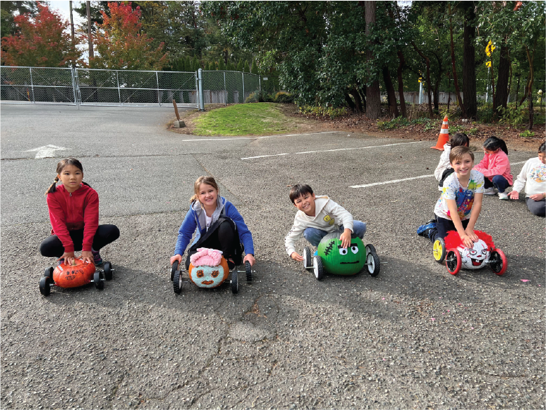 elementary kids with pumpkin racers